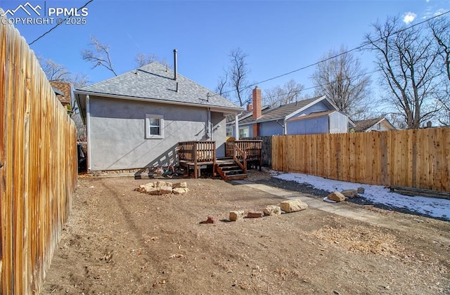 rear view of house with a wooden deck