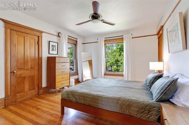 bedroom featuring light wood-style floors and ceiling fan