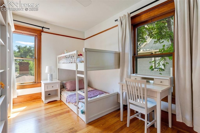 bedroom featuring wood finished floors and baseboards