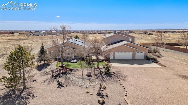 view of front of property featuring driveway, a garage, and stucco siding