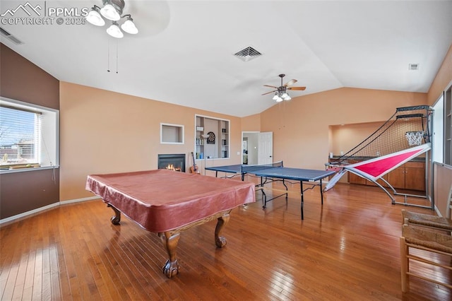 recreation room featuring lofted ceiling, ceiling fan, hardwood / wood-style flooring, and visible vents