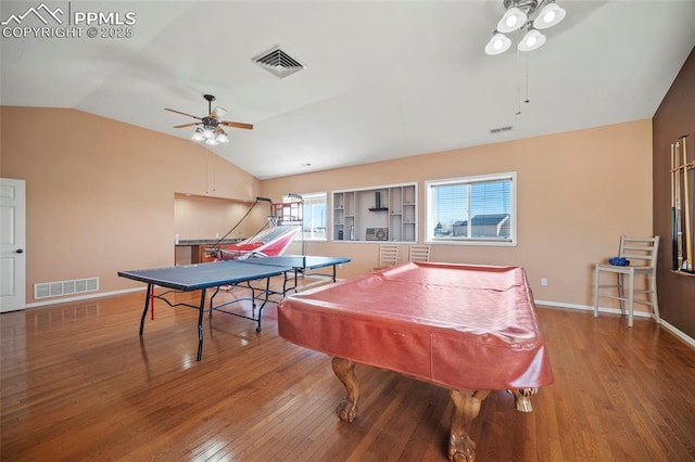 rec room featuring vaulted ceiling, wood finished floors, visible vents, and a ceiling fan