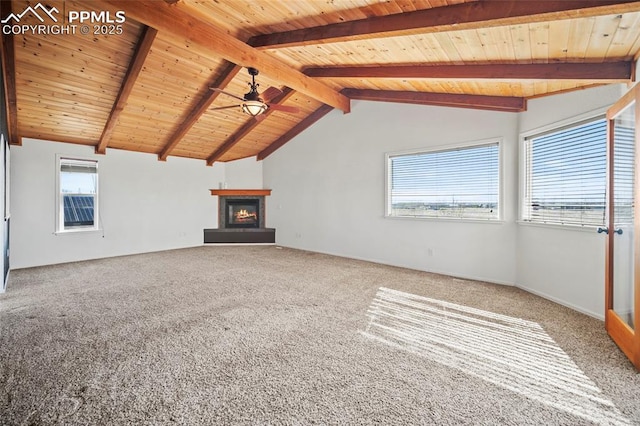 unfurnished living room with a glass covered fireplace, wood ceiling, and vaulted ceiling with beams