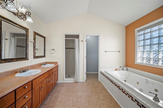 bathroom with lofted ceiling, a tub with jets, a stall shower, and a sink