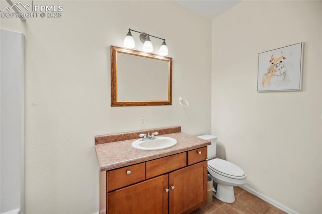 bathroom featuring toilet, tile patterned flooring, and vanity