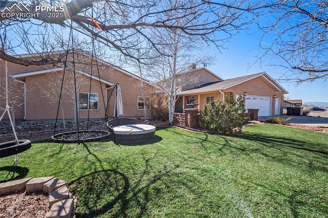 exterior space with a garage and a trampoline