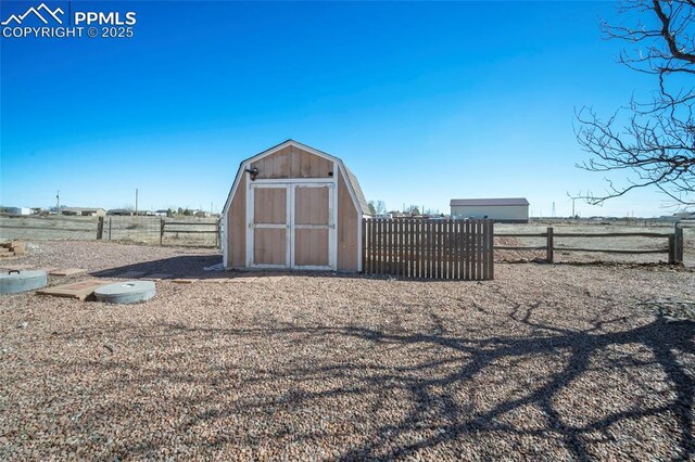 view of shed featuring fence