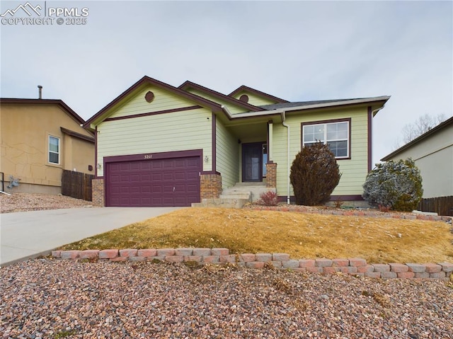 view of front facade featuring a garage, driveway, brick siding, and fence