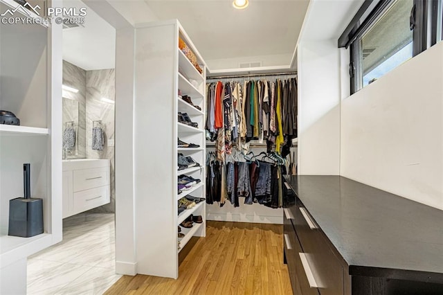 spacious closet with visible vents and light wood-type flooring