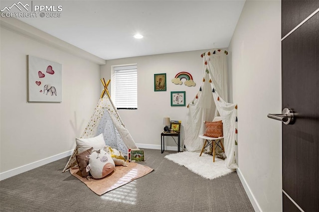 recreation room with baseboards, dark colored carpet, and recessed lighting