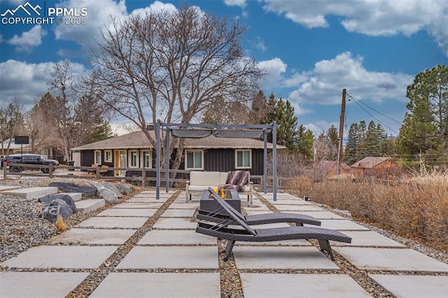 back of property featuring board and batten siding and a patio area