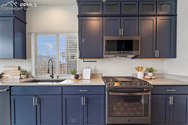 kitchen with stainless steel appliances, glass insert cabinets, a sink, and light stone counters