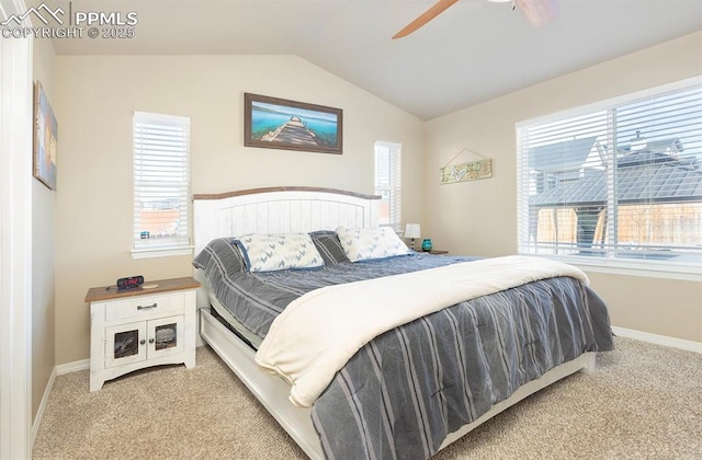 carpeted bedroom featuring lofted ceiling, multiple windows, and baseboards