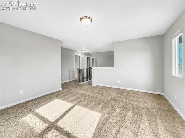 unfurnished living room with carpet floors and baseboards