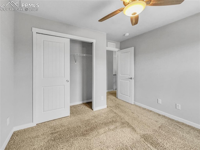 unfurnished bedroom with carpet, a closet, visible vents, ceiling fan, and baseboards