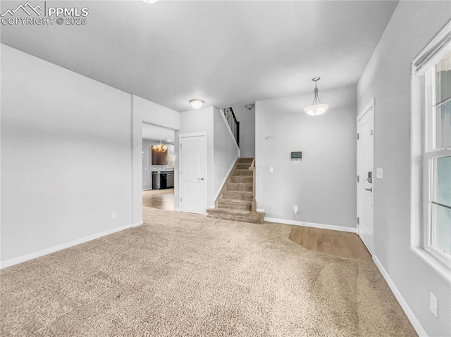 interior space with stairs, carpet floors, and baseboards