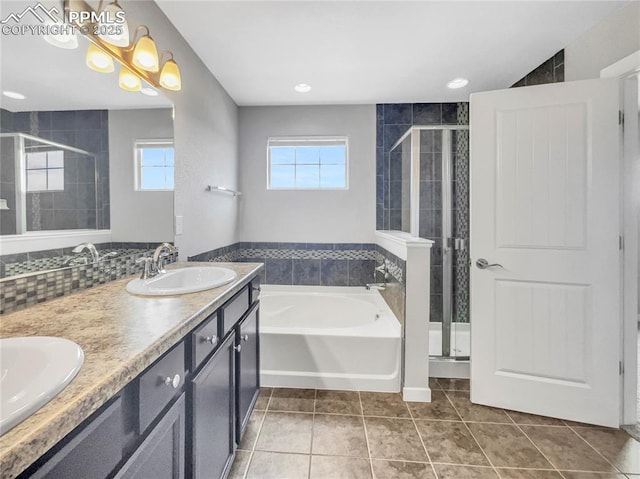 bathroom featuring double vanity, tile patterned floors, a garden tub, a shower stall, and a sink