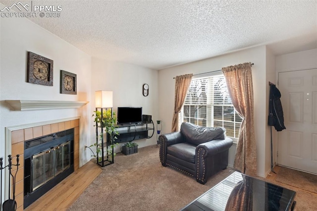 living room with a textured ceiling and a fireplace