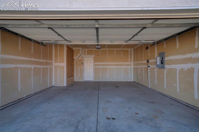 garage featuring electric panel and a garage door opener