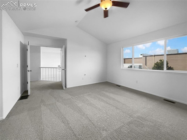 carpeted spare room with lofted ceiling and ceiling fan