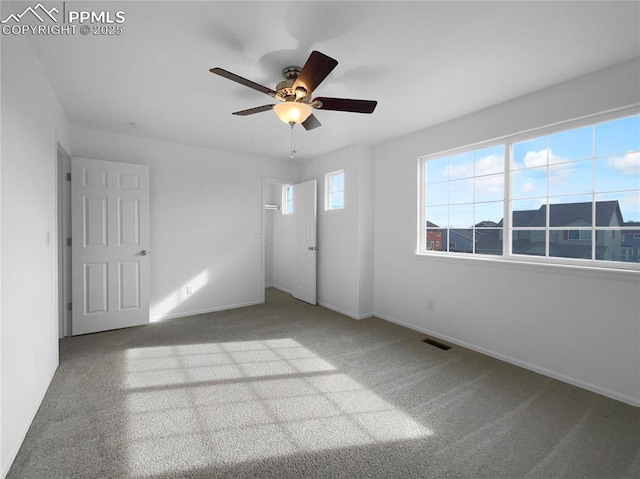 carpeted spare room with ceiling fan