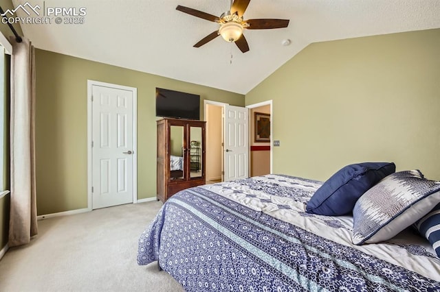 carpeted bedroom with a ceiling fan, vaulted ceiling, and baseboards