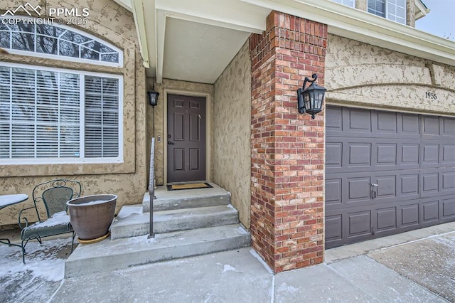 entrance to property featuring brick siding