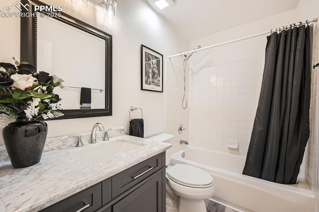 bathroom featuring vanity, toilet, and shower / bath combo with shower curtain