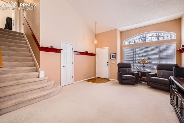 sitting room featuring carpet floors, high vaulted ceiling, baseboards, and stairway