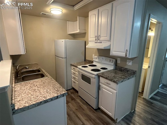 kitchen with white appliances, visible vents, dark wood-style flooring, under cabinet range hood, and a sink