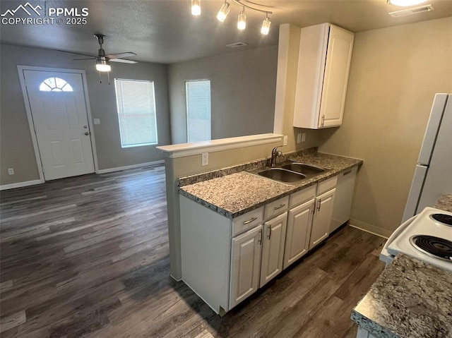 kitchen with white appliances, visible vents, dark wood-style floors, white cabinetry, and a sink