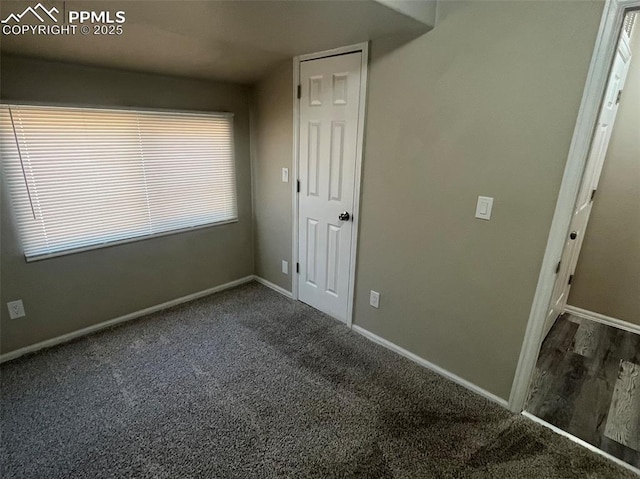 empty room with carpet and baseboards