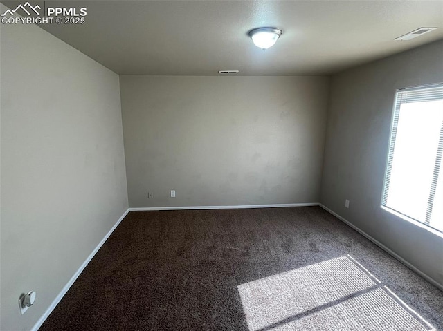 carpeted spare room with baseboards and visible vents