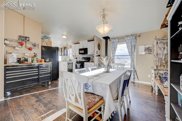 dining area with sink and dark wood-type flooring