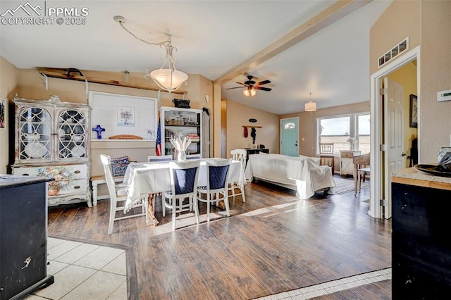 dining area with ceiling fan, wood-type flooring, and lofted ceiling with beams