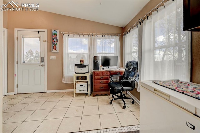 office area featuring lofted ceiling and light tile patterned flooring