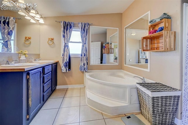 bathroom featuring a bath, tile patterned flooring, and vanity