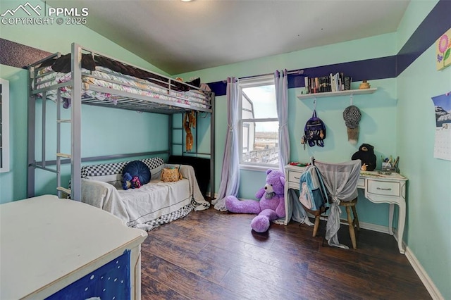 bedroom with dark wood-type flooring and lofted ceiling