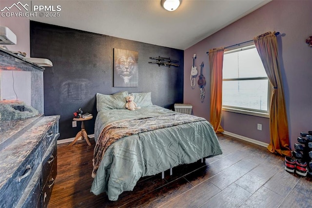 bedroom with lofted ceiling and dark hardwood / wood-style floors