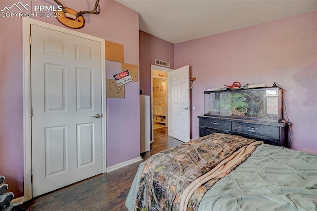 bedroom with dark hardwood / wood-style flooring