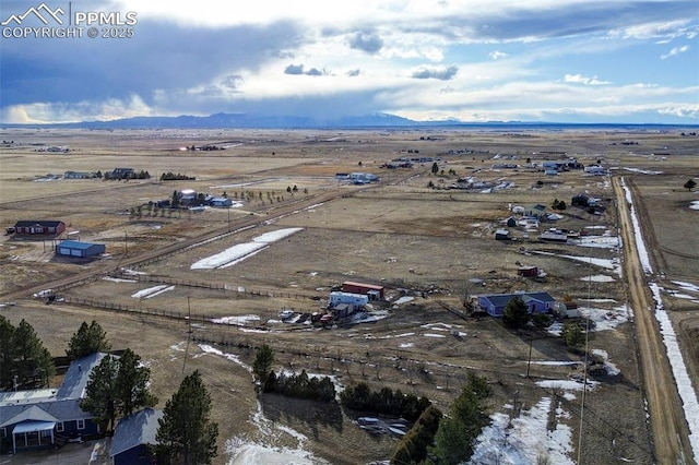 birds eye view of property featuring a mountain view and a rural view