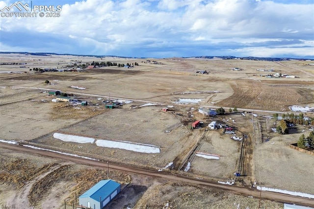 birds eye view of property with a rural view