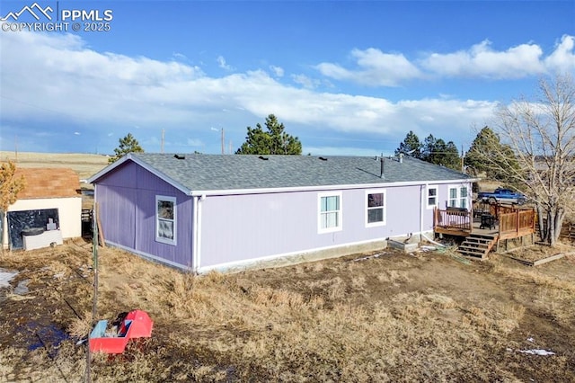 rear view of house featuring a deck