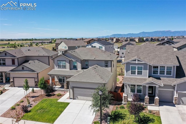 view of front of home with a garage and a mountain view