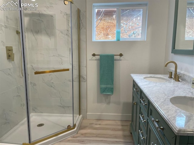 bathroom with hardwood / wood-style flooring, walk in shower, and vanity