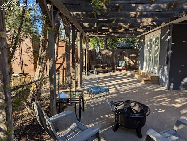 view of patio / terrace with a pergola and a fire pit