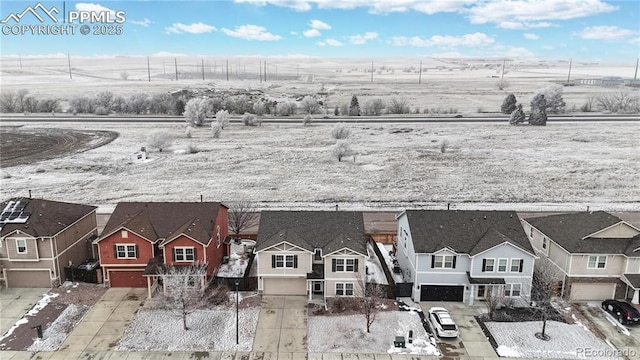 snowy aerial view with a residential view