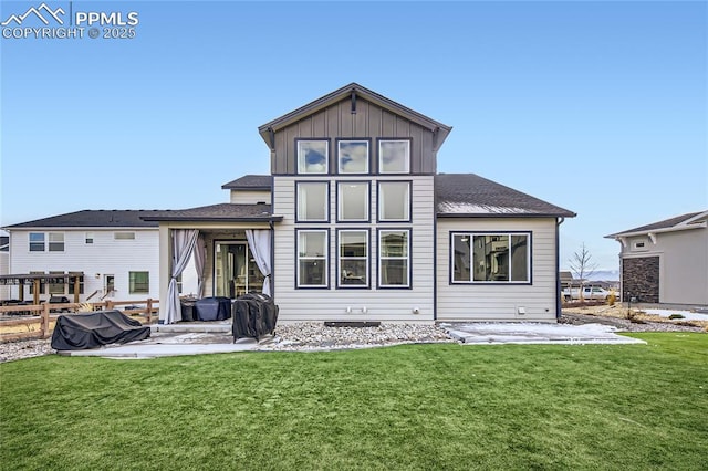 rear view of property with a patio and a lawn