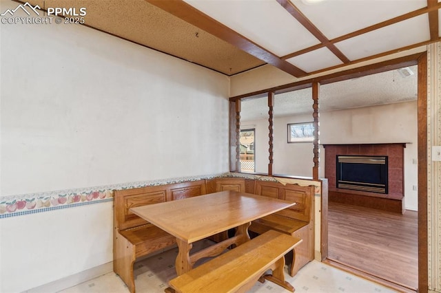 dining space with a tile fireplace