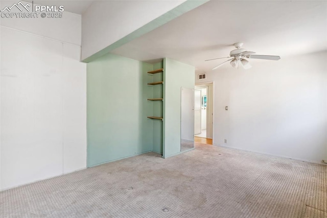 unfurnished room with a ceiling fan, visible vents, and light colored carpet